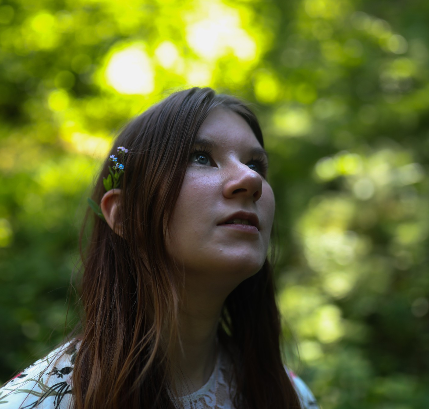 girl looks for magic in the forest