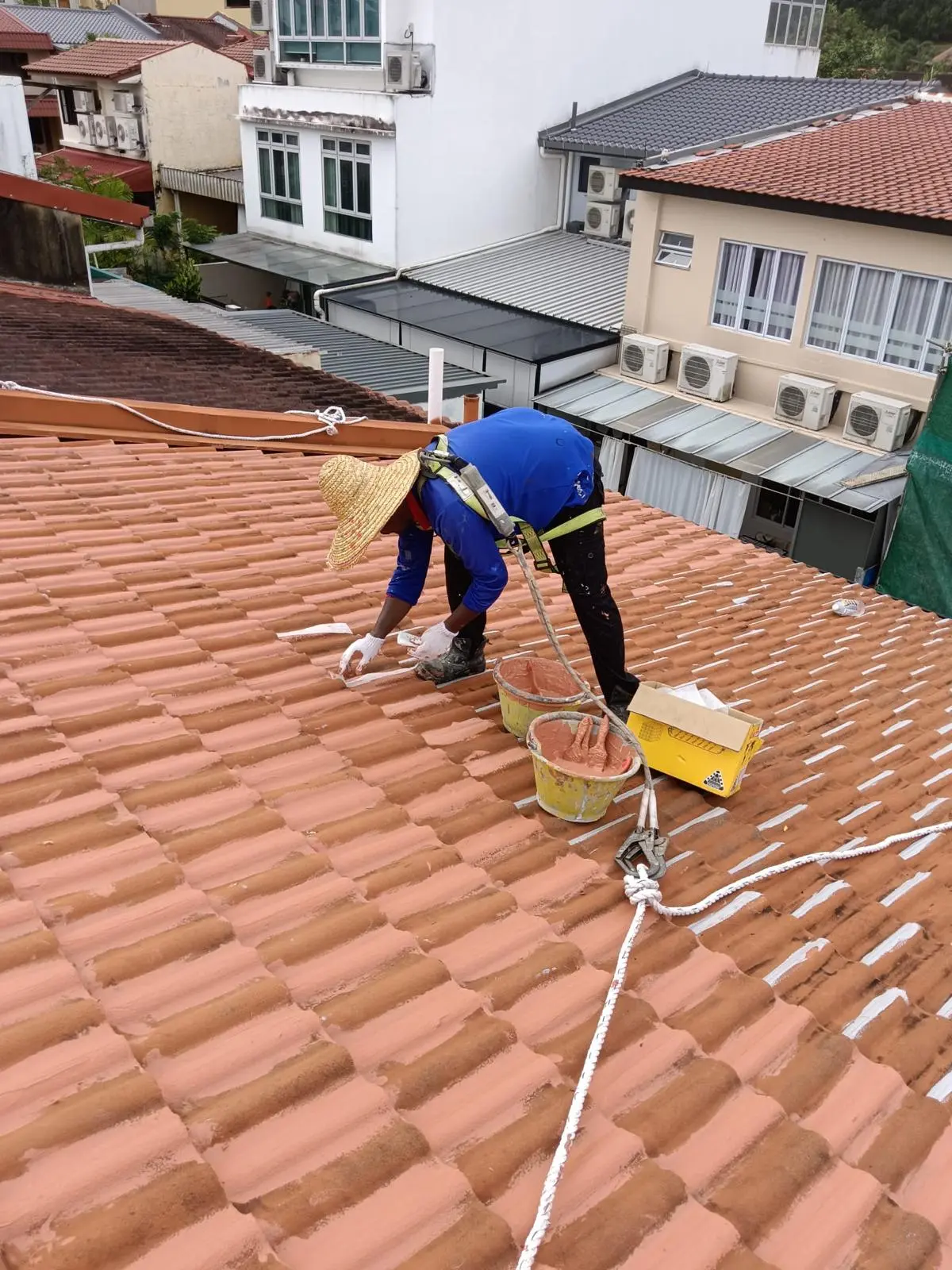 alt="roof leak repair Singapore residential building"