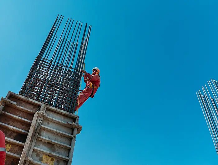 Ironworker tying a reinforcing-bar column cage