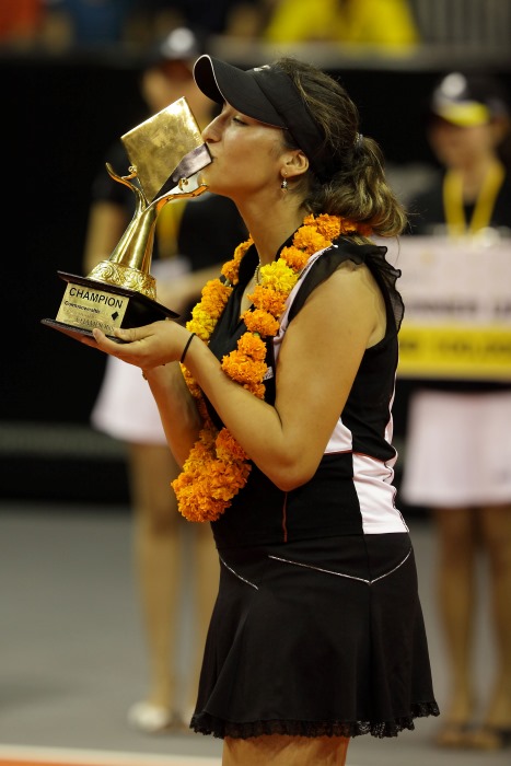 Aravane Rezai kisses the trophy after she won the womens-singles final