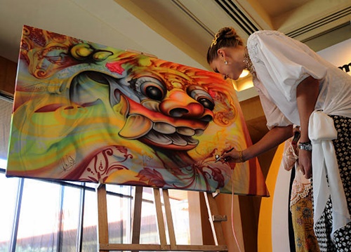 Nadia Petrova of Russia signs a picture during a drawing ceremony