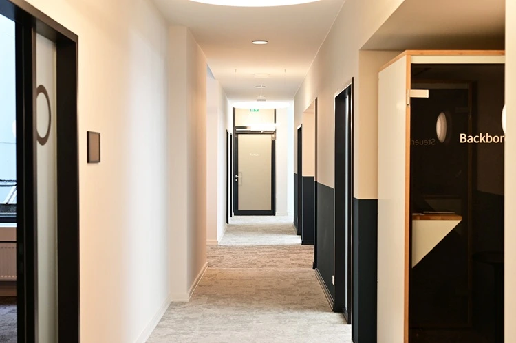 Telefonbox im Flur mit hohen Decken und modernem Lichtkonzept