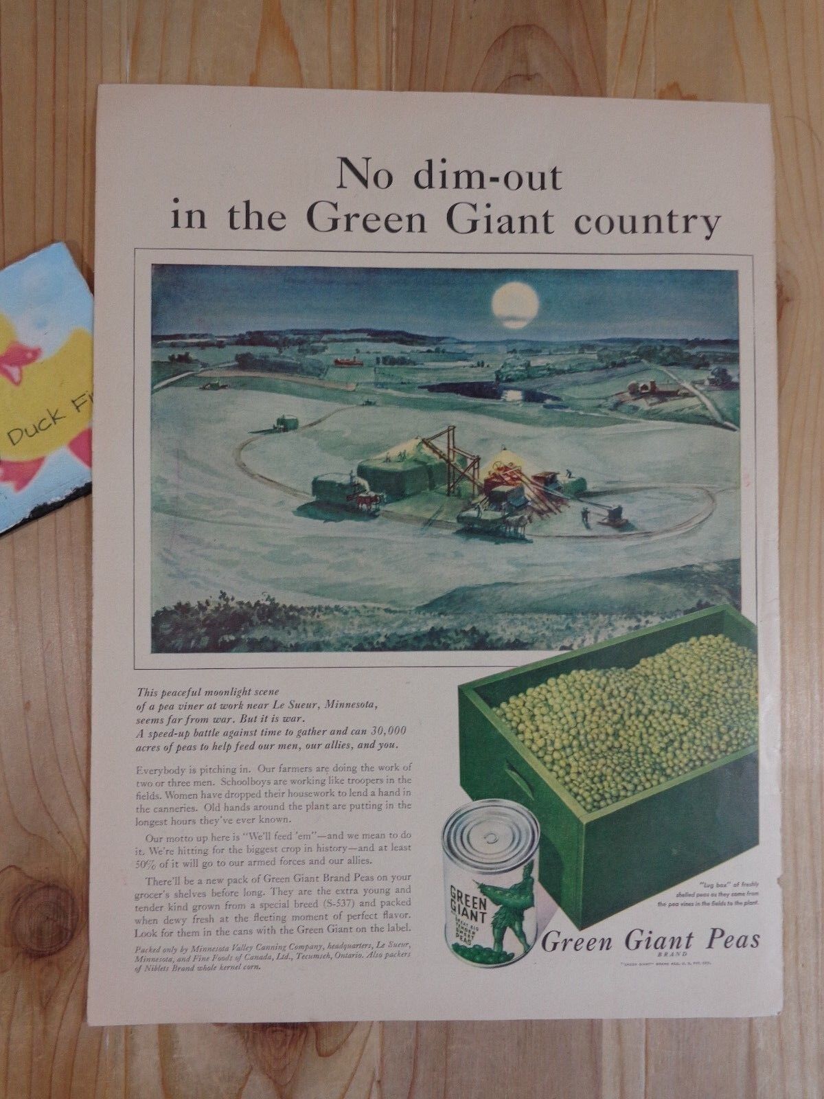  A captivating vintage advertisement likely illustrated by John C Howard, featuring a scenic green giant country.