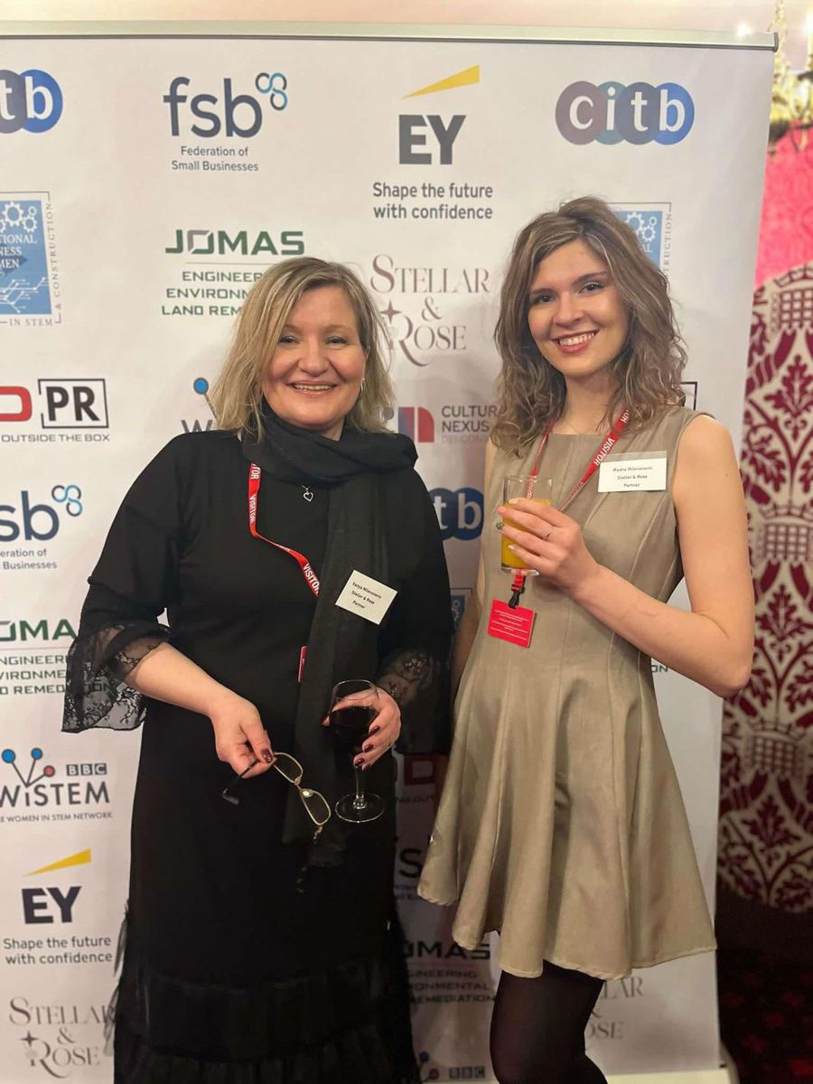 Vanya and Masha Milovanovic of Stellar and Rose at the Women in STEM and Construction awards at the House of Lords, in front of the sponsor backdrop