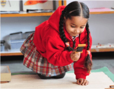 Montessori Student Playing with Equipments