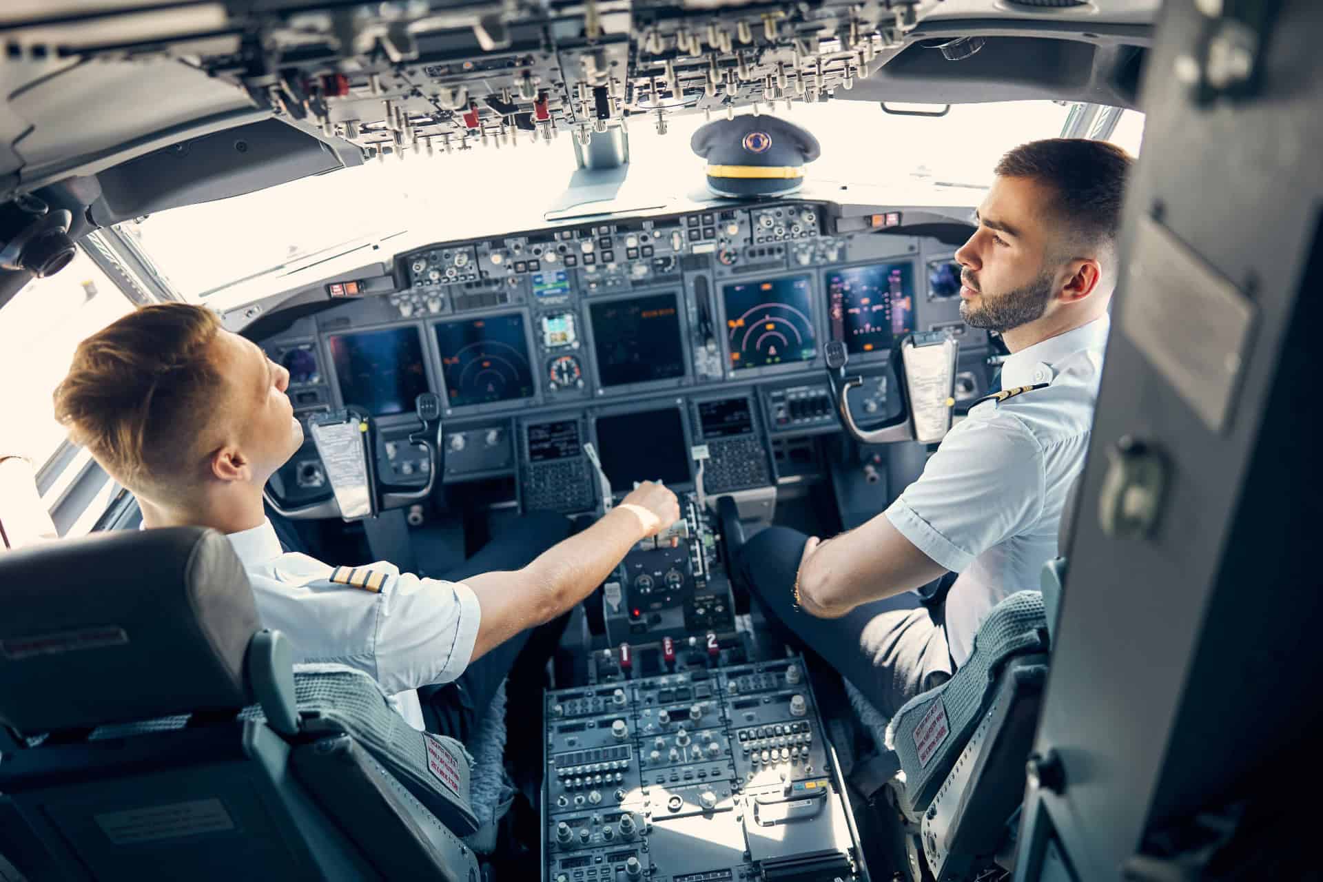two pilots discussing flight plan in cockpit