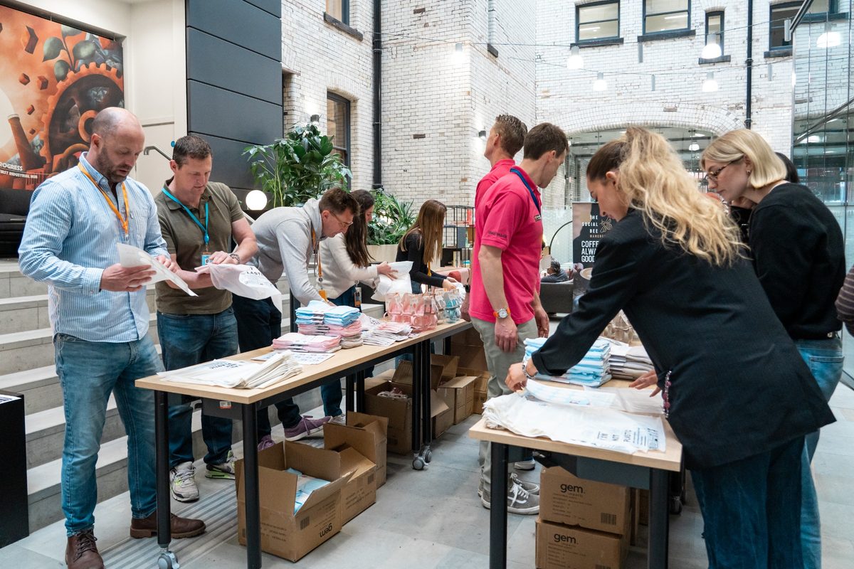 Corporate volunteers assembling charity kits together