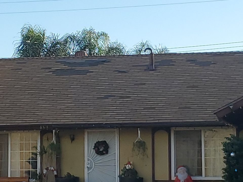 Wind-damaged asphalt shingle roof in Montebello, CA