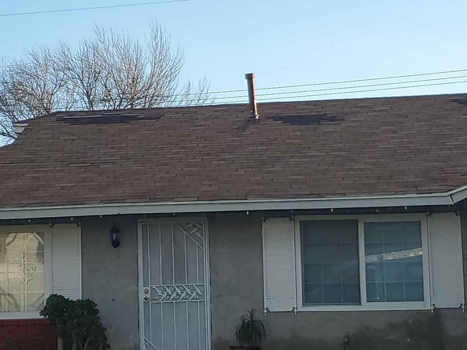 Missing shingles caused by high winds on residential roof